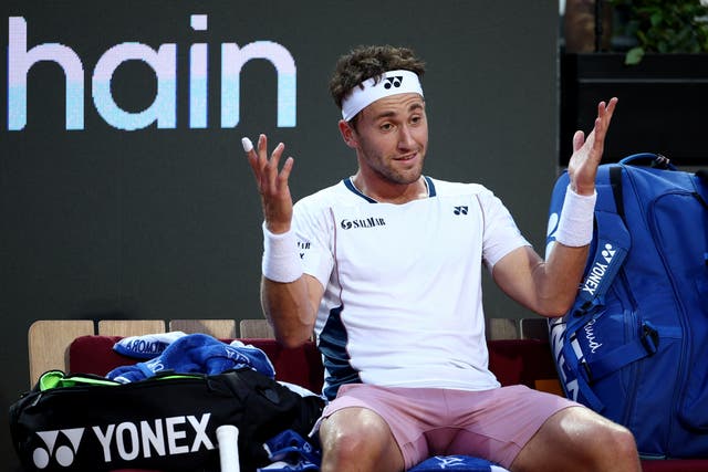 <p>Casper Ruud reacts during his 6-0 6-1 defeat to Jannik Sinner </p>